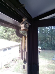 Wind chimes with brass chimes on porch