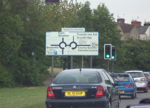 Road signs in England with two roundabouts